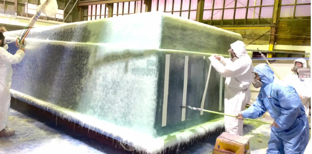 Bayside factory in Whakatane - a fibreglass pool mould being finished by hand