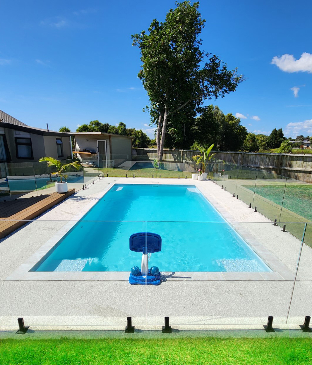 White Knight fibreglass pool with corner entry steps installed on a lawn