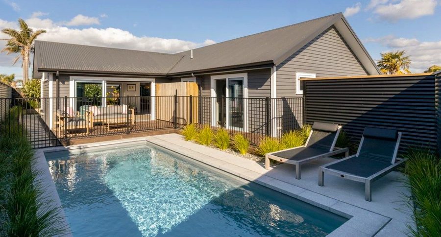 Retreat fibreglass pool with decking and loungers, Tauranga