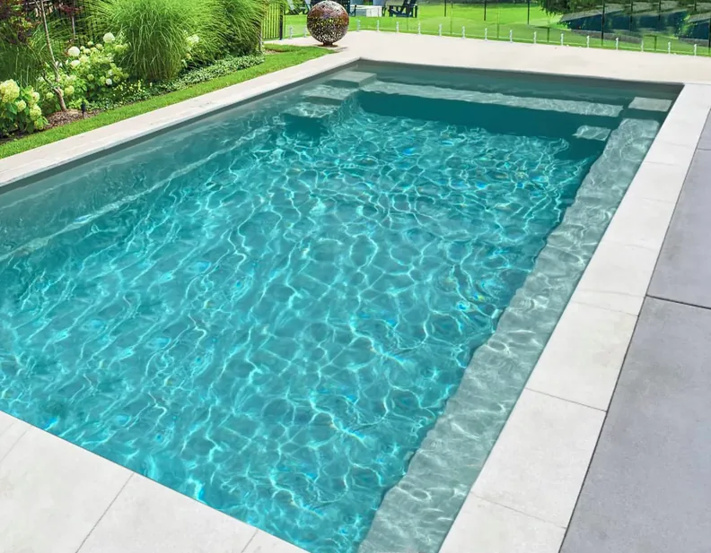 Element fibreglass pool in a landscaped garden